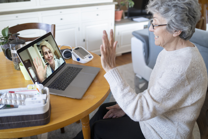 Senior woman having online consultation with her doctor in a video call